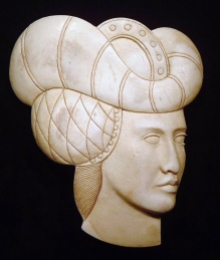 'Padded Hat Woman' (carved and stained antler) by Maureen Morris